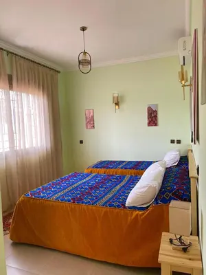 a bedroom with a large bed in a room at Dyafat Abla in Oulad Akkou