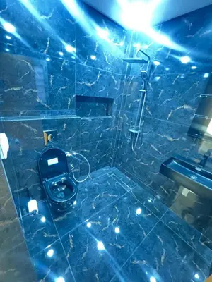 a blue bathroom with a toilet and a sink at Dar élégance in Oulad Akkou