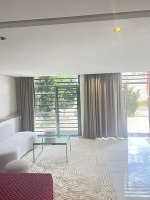 a living room with a couch and a glass table at Dar élégance in Oulad Akkou
