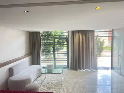 a living room with a white couch and a glass table at Dar élégance in Oulad Akkou