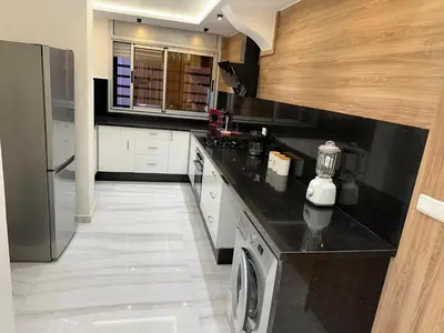 a kitchen with a washer and dryer on a counter at Dar élégance in Oulad Akkou