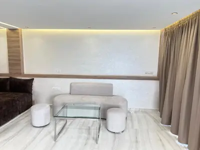 a living room with a couch and a glass table at Dar élégance in Oulad Akkou