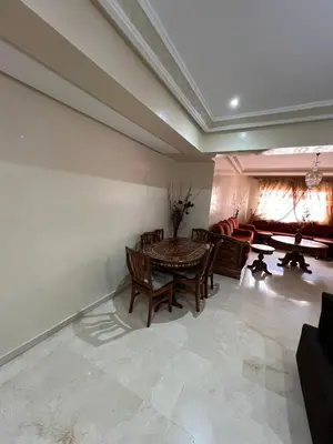 a living room with a table and a couch at appartement amine in Oulad Akkou