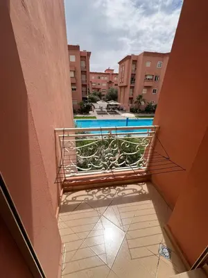a balcony with a view of a swimming pool at appartement amine in Oulad Akkou