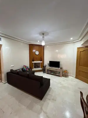 a living room with a couch and a tv at appartement amine in Oulad Akkou