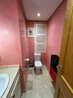 a bathroom with a toilet and a sink at appartement amine in Oulad Akkou
