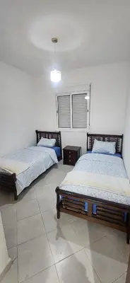 a bedroom with two beds and a window at MBS imo in Oulad Akkou