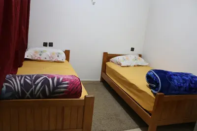 two twin beds in a room at Les jardins d'Ifrane in Ifrane