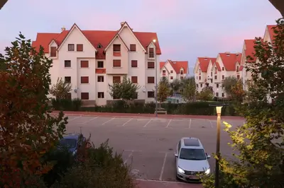 a car parked in a parking lot in front of a building at Les jardins d'Ifrane in Ifrane