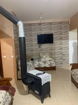 a large black pipe in a room with a bed at Les jardins d'Ifrane in Ifrane