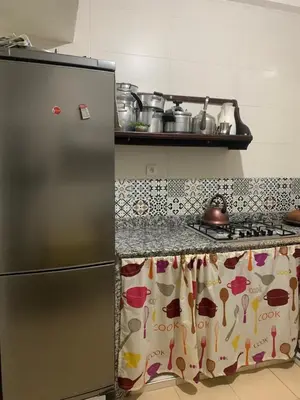 a kitchen with a refrigerator and a counter top at Les jardins d'Ifrane in Ifrane