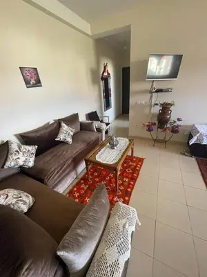 a living room with a couch and a coffee table at حدائق افران in Oulad Akkou