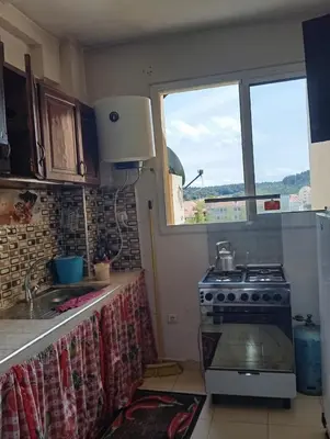 a kitchen with a stove and a window at حدائق افران in Oulad Akkou