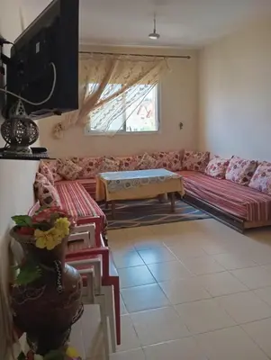a living room with a couch and a table at حدائق افران in Oulad Akkou