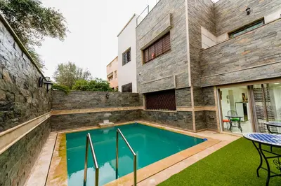 a swimming pool in the backyard of a house at Riad Les Champs De Fès in Fès