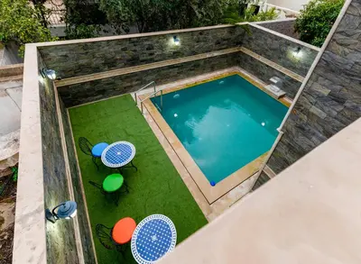 an overhead view of a swimming pool with two tables and chairs at Riad Les Champs De Fès in Fès