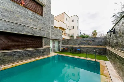 a swimming pool in the backyard of a house at Riad Les Champs De Fès in Fès