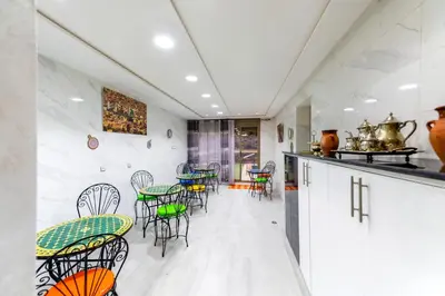 a room with tables and chairs in a kitchen at Riad Les Champs De Fès in Fès