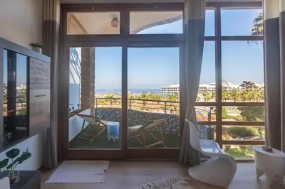 a room with a large window with a view of the ocean at Refined studio with sea view in Oulad Akkou