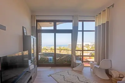 a living room with a large window with a view at Refined studio with sea view in Oulad Akkou