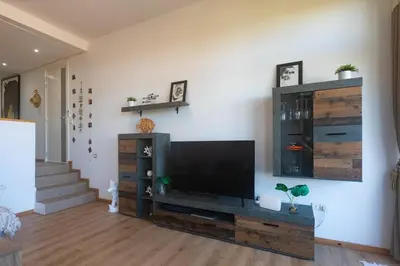 a living room with a large flat screen tv at Refined studio with sea view in Oulad Akkou