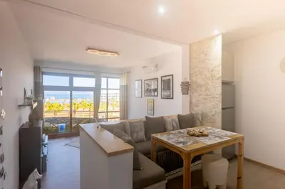 a living room with a couch and a table at Refined studio with sea view in Oulad Akkou