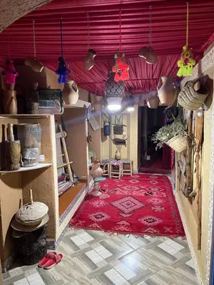 a room with a red rug and a red ceiling at Auberge Lwalida in Ouled Sguir