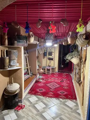 a room with a red rug and a red ceiling at Auberge Lwalida in Ouled Sguir