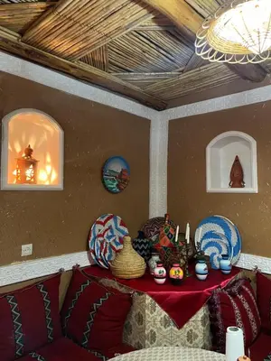 a room with a table with a red table cloth at Auberge Lwalida in Ouled Sguir