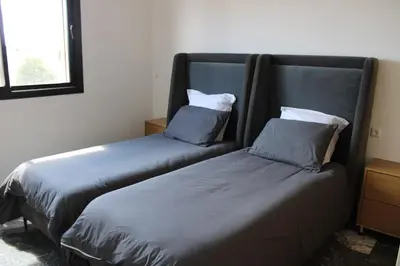 two beds sitting next to each other in a room at Villa Bakhta in Najem