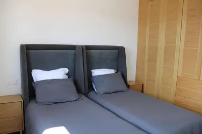a bed with two pillows on it in a room at Villa Bakhta in Najem