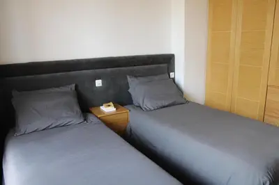 two beds sitting next to each other in a room at Villa Bakhta in Najem
