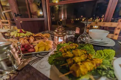 a table topped with plates of food on a table at Unique Desert Camp in Merzouga