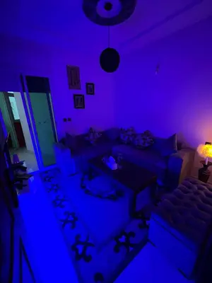 a purple living room with a couch and a table at Perfect Cozy Apartment in City Center Hamrya in Meknès