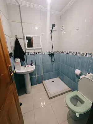 a bathroom with a shower and a toilet and a sink at Perfect Cozy Apartment in City Center Hamrya in Meknès