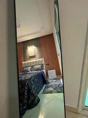 a mirror reflection of a bed in a room at Perfect Cozy Apartment in City Center Hamrya in Meknès