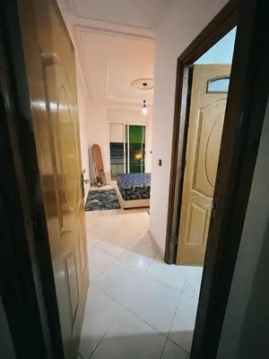 a hallway with a door leading to a bedroom at Perfect Cozy Apartment in City Center Hamrya in Meknès