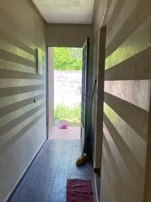 a hallway with a door open to a room with a doorway at Ourika in Aghbalou