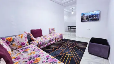 a living room with a couch and a table at Lovelystay in Fes in Fès
