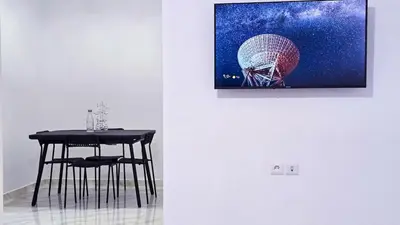 a table and chair in a room with a picture at Lovelystay in Fes in Fès
