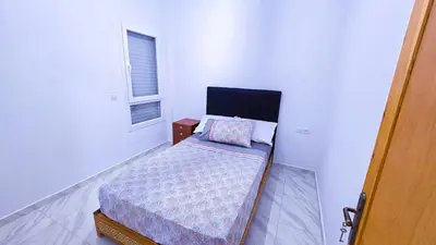 a small bed in a white room with a window at Lovelystay in Fes in Fès