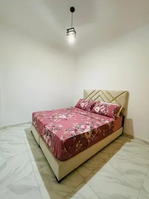 a bed in a room with a red comforter at Lovelystay in Fes in Fès