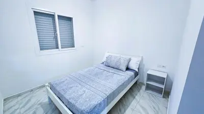 a small bed in a white room with a window at Lovelystay in Fes in Fès