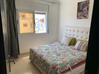 a bedroom with a bed and a window at martil in Oulad Akkou