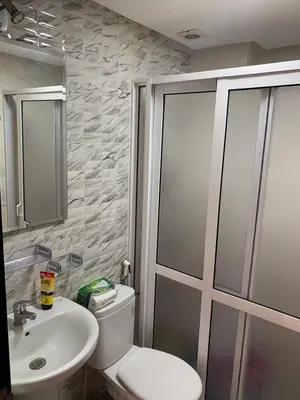 a bathroom with a toilet and a sink at martil in Oulad Akkou