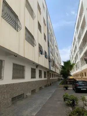 a building with a car parked in front of it at martil in Oulad Akkou