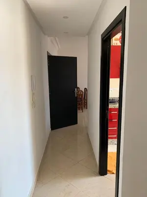a hallway with a black door in a room at martil in Oulad Akkou