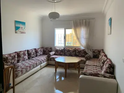 a living room with a couch and a table at martil in Oulad Akkou