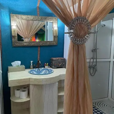 a bathroom with a sink and a mirror at Bedouin House in Merzouga