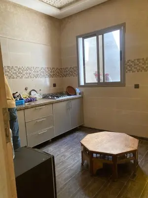 a room with a kitchen with a table and a window at Ourika in Ourika